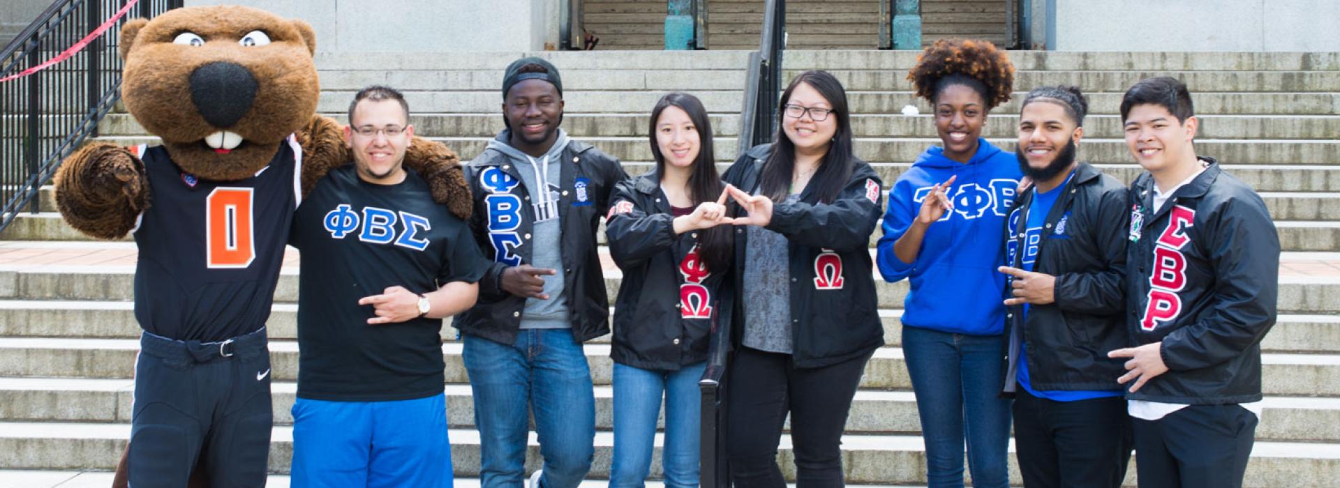 Fraternity and Sorority members standing on MU steps with Benny