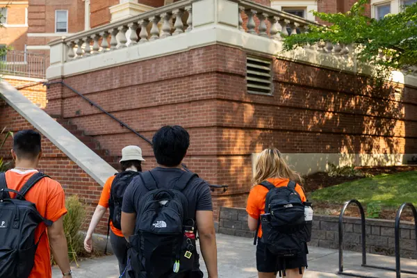 Four students walk to Weatherford Hall