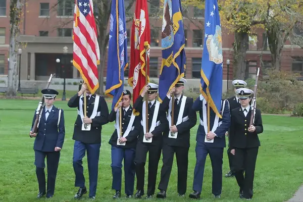 ROTC student carrying flags
