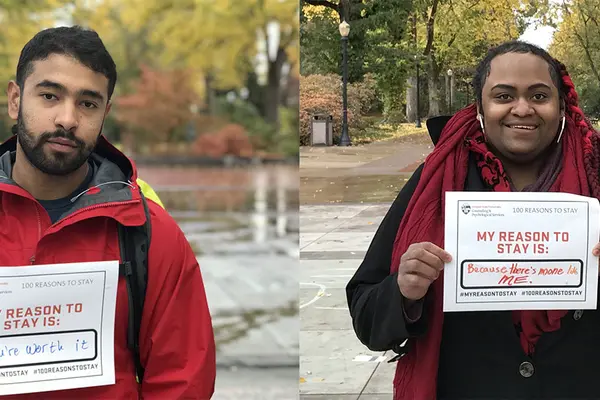 Two students hold up signs; one reads: "My reason to stay is: You're worth it". Another reads: "My reason to stay is: Because there's no one like me".