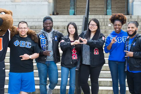 Fraternity and Sorority members standing on MU steps with Benny