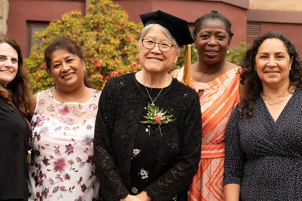 Janet Nishihara, center, and Educational Opportunities Program colleagues pose outside of Waldo Hall. 