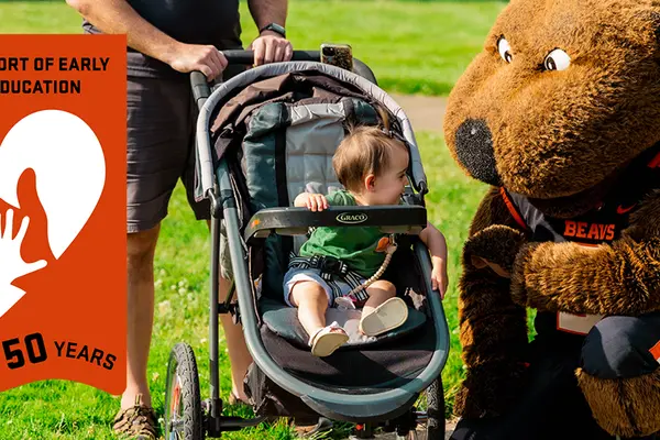 toddler interacts with Benny the Beaver