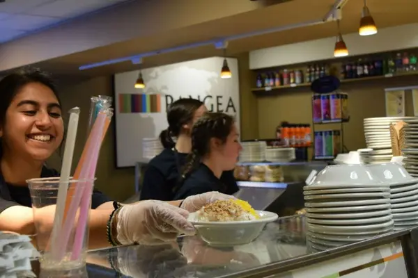 Students prepare food during the Pangea Cafe Takeover Event