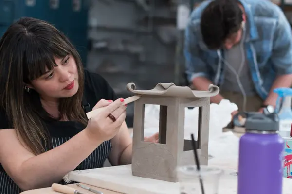 Student uses clay to make small house
