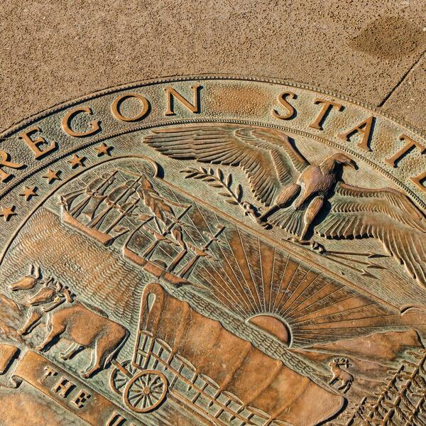 Oregon State College seal on ground